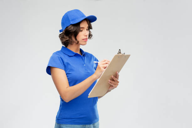 istock delivery girl with clipboard and pen writing 1367983796
