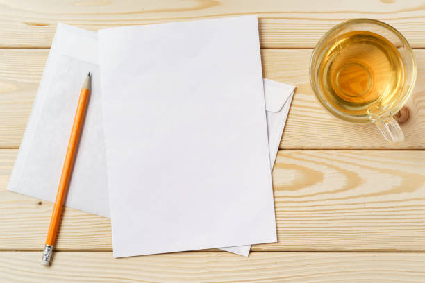 istock Envelopes with cup of tea on wooden table top 1367984216
