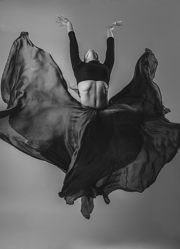 Woman Dancing with Silk Fabric dress, Modern Dancer in Fluttering Waving Cloth on Gray Background