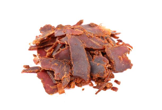 istock Heap of beef jerky on white background. 1367984927