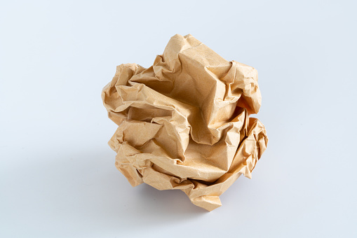 A ball of crumpled paper as a concept of a business idea, project or startup isolated on a white background