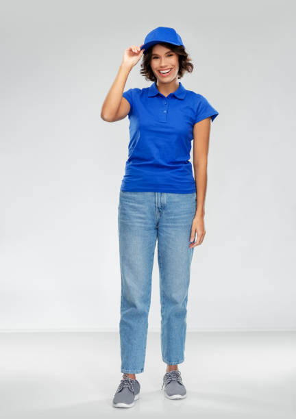 happy smiling delivery woman in blue uniform stock photo