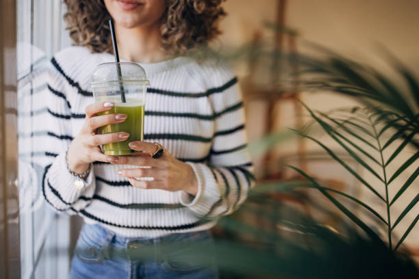 istock Young woman holding a smoothie 1367985266