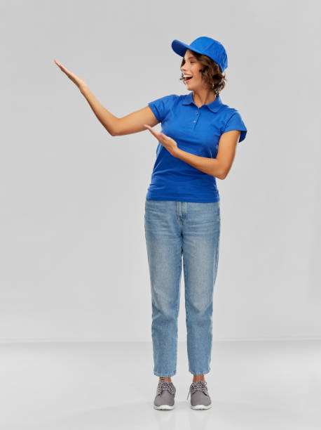 istock happy smiling delivery woman in blue uniform 1367986658