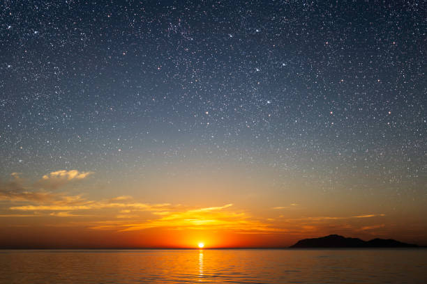 a sunrise at sea with beautiful gradient and stars stock photo