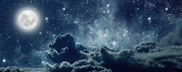 istock backgrounds night sky with stars and clouds. 1367987037