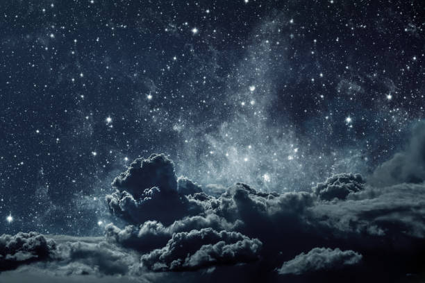 istock backgrounds night sky with stars and clouds. 1367987042