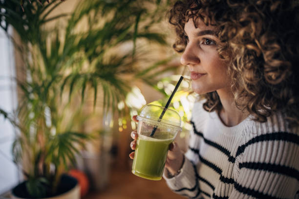 istock Young woman drinking smoothie 1367988039