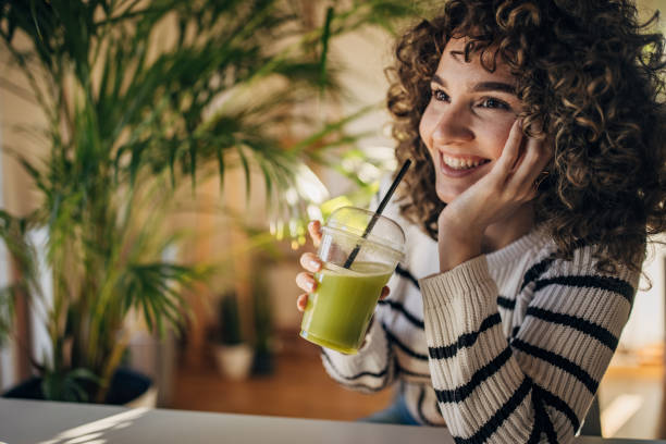 istock Young woman drinking smoothie 1367988059