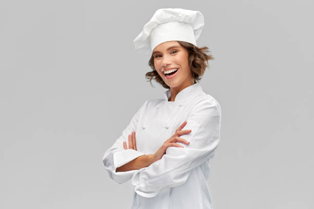 istock smiling female chef in toque with crossed arms 1367988134