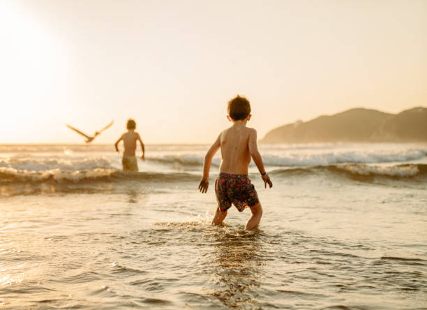 istock Boys playing at the beach 1367988431