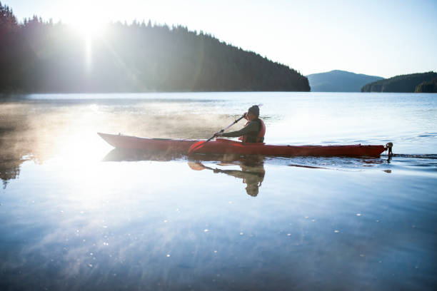 istock Senior man kayaking on sunrise. 1367988700