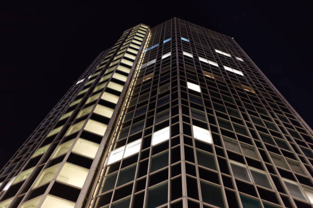 High building in Halmstad. Look up towards night sky. Pattern. Exterior. Design. Background image. Illuminated windows. Skyscraper.