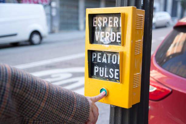 istock senior Caucasian woman's hand pressing the yellow traffic light button with green button 1367989438