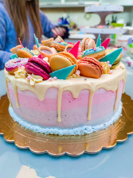 Beautiful Birthday Cake Decorated with Colorful Macarons, Donuts, Sprinkles,....