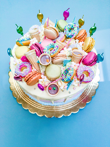 Beautiful Birthday Cake Decorated with Colorful Macarons, Donuts, Sprinkles,....