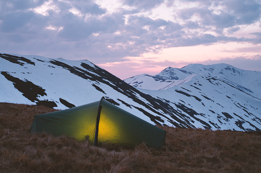 Green tent in spring mountains