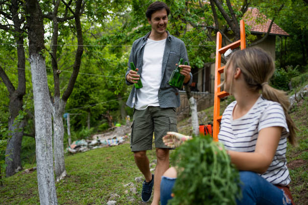 istock Young couple taking break from agricultural activity at the orchard 1367991211