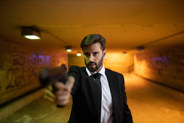 istock Caucasian male secret agent ponting a gun 1367991727