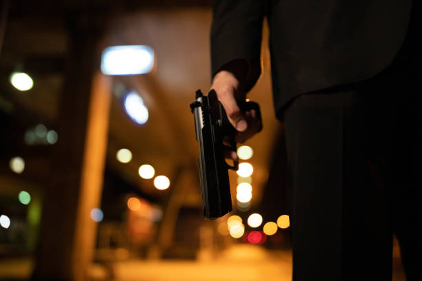 istock Unrecognizable man holding the gun 1367991748