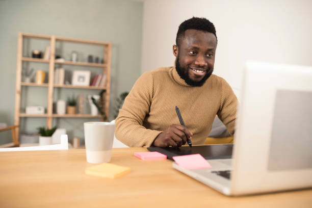 istock Young African-American designer working as a freelancer 1367993027