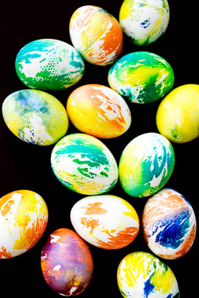 istock Top view multicolored eggs on a black isolated background. Happy Easter card. 1367994373