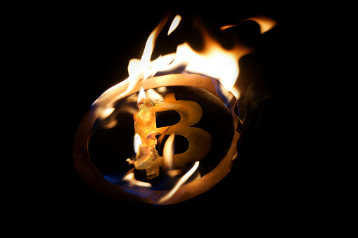 A burning bitcoin symbol. The end or just the beginning of crypto?