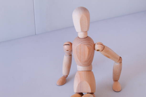 istock Wooden figure as a model for exercising at home 1367995395