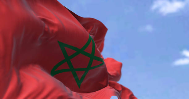 Detail of the national flag of Morocco waving in the wind on a clear day stock photo