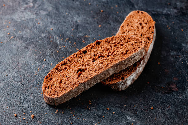 slices of rye bread on a black stone surface
