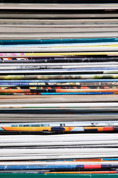 istock Full frame stack of magazines in front of bookshelf 1367998130