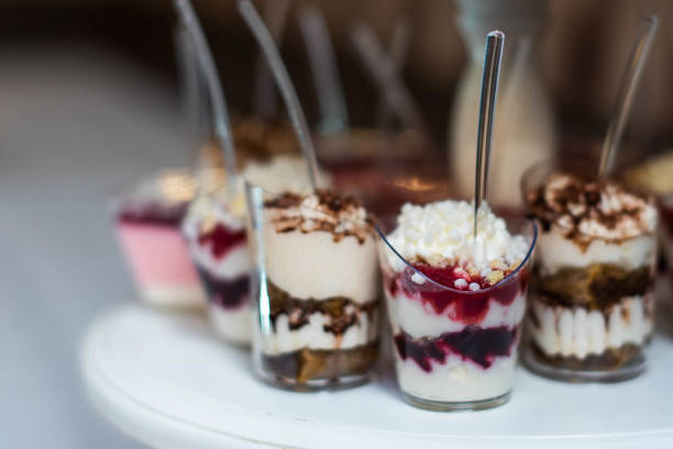 istock dessert buffet. assortment of sweets. catering service table. desserts garnished with nuts, jellies and berries. Preparing for holiday and decorating candy bar. 1367998382