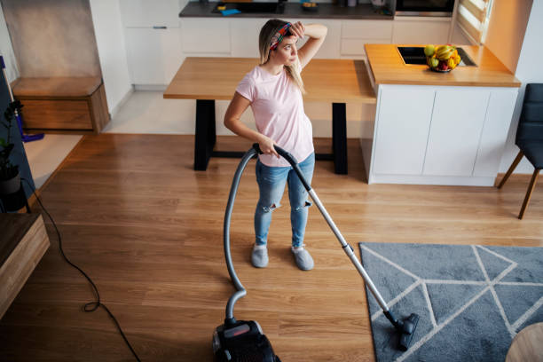 istock A tired woman doing chores at her home. 1368000340