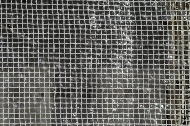 istock Texture of plastic mesh. Squares of white threads. Selective foc 1368000757