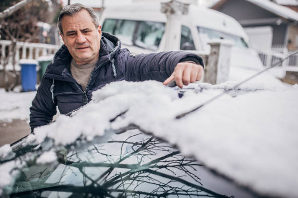 istock Winter, clearing the snow from the car 1368001767