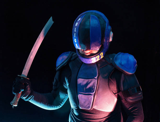istock Cyberpunk future concept. Bionic cyborg police officer with short samurai sword stands in dark. Halfman robot looks at camera. Futuristic science fiction scene. 1368003169