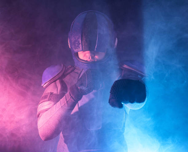 istock Male robot cop waves and punches his fits in dark. Halfman is ready for fight. Bionic cyborg looks at camera. Red blue light. Law and Order concept. World of tomorrow. 1368003170