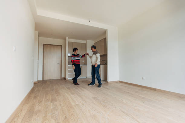 istock Happy couple in their new empty apartment 1368003232