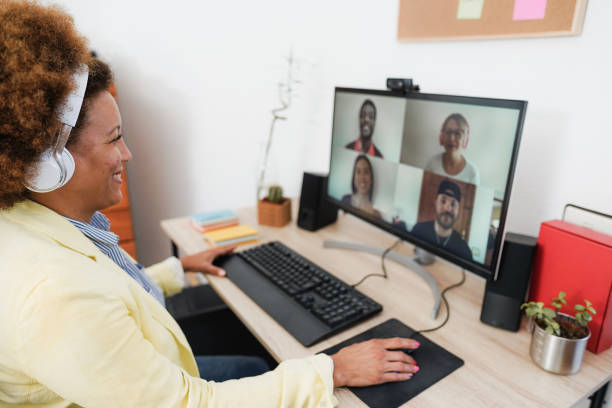 istock African woman having video call with her colleagues using computer app - Soft focus on right hand 1368003683
