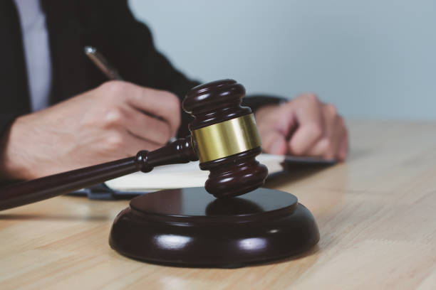 istock Man hand document with Judge gavel on table, closeup 1368004303