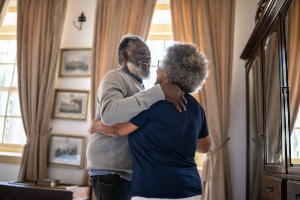 istock Senior couple dancing at home 1368004819