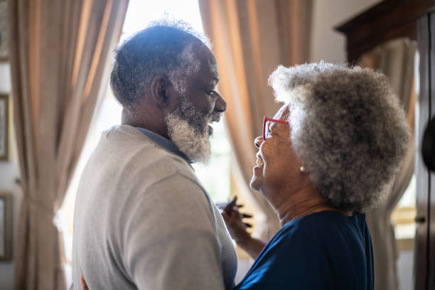 istock Senior couple dancing at home 1368004823