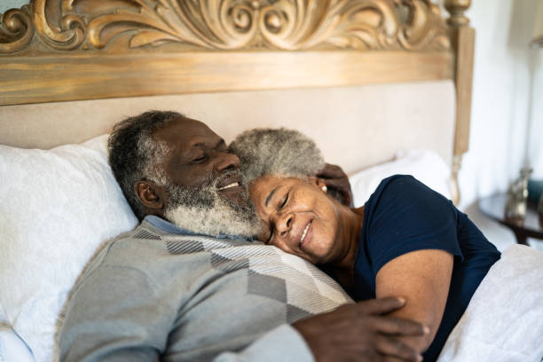 istock Senior couple lying down in bed at home 1368004894