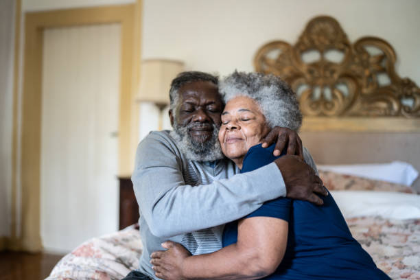 istock Senior couple hugging each other at home 1368004898