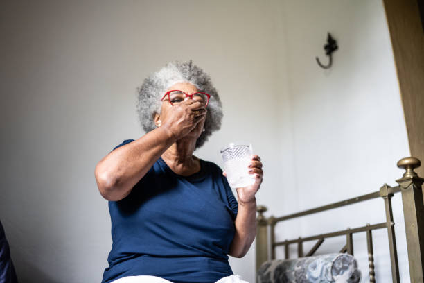 istock Senior woman taking medicines at home 1368004979