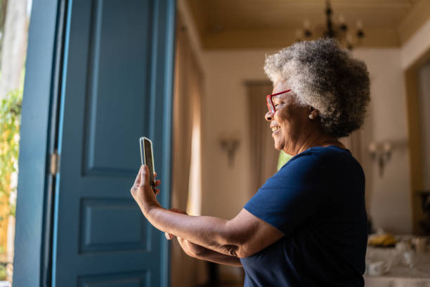 istock Senior woman doing a video call on mobile phone 1368005043
