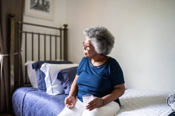 istock Contemplative senior woman taking medicines at home 1368005249