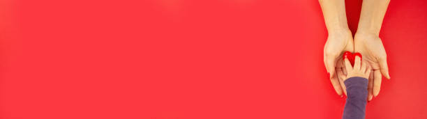 istock valentine. heart in hands on a red background. 1368007668