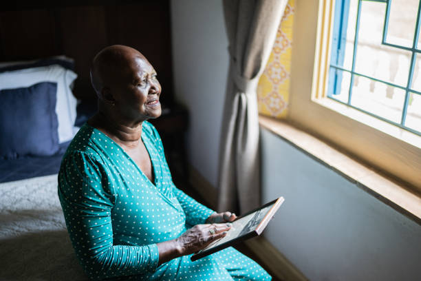 istock Senior woman holding a picture frame missing someone at home 1368009964