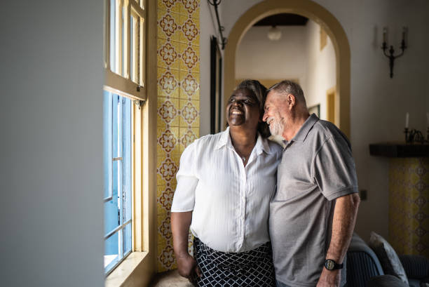 istock Contemplative senior couple looking through the window 1368010145